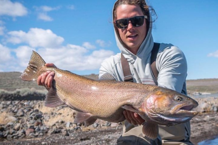 a man holding a fish