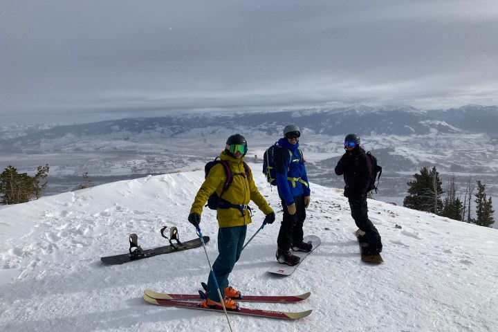 a group of people riding skis on top of a snow covered slope