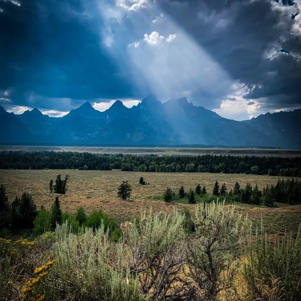 Teton range with a ray of sunlight casting down from Teton view.