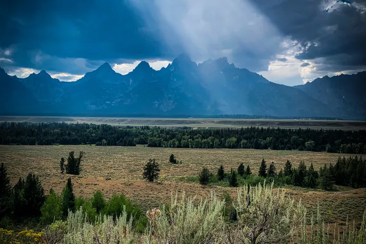 Teton range with a ray of sunlight casting down from Teton view.