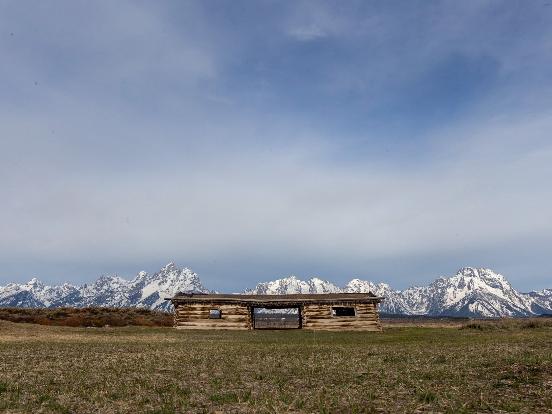 a field with a mountain in the background