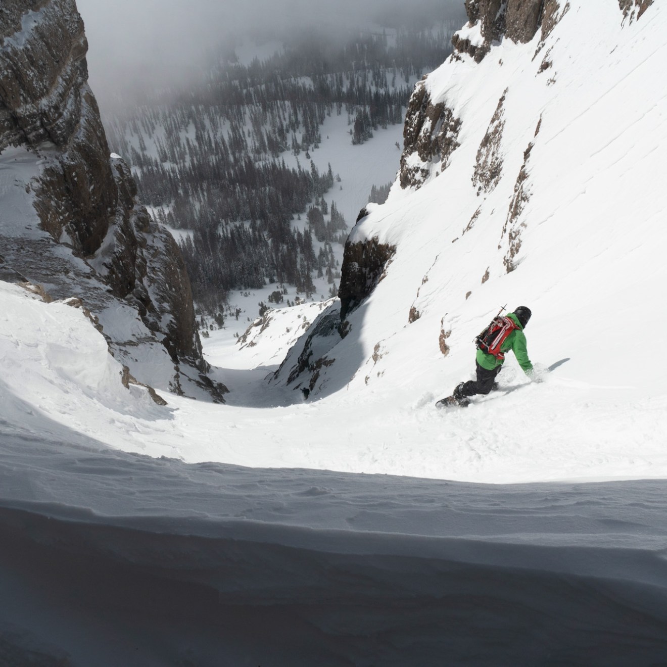 a man riding skis down a snow covered slope