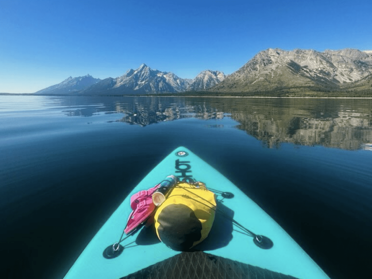 a bridge over a body of water with a mountain in the background